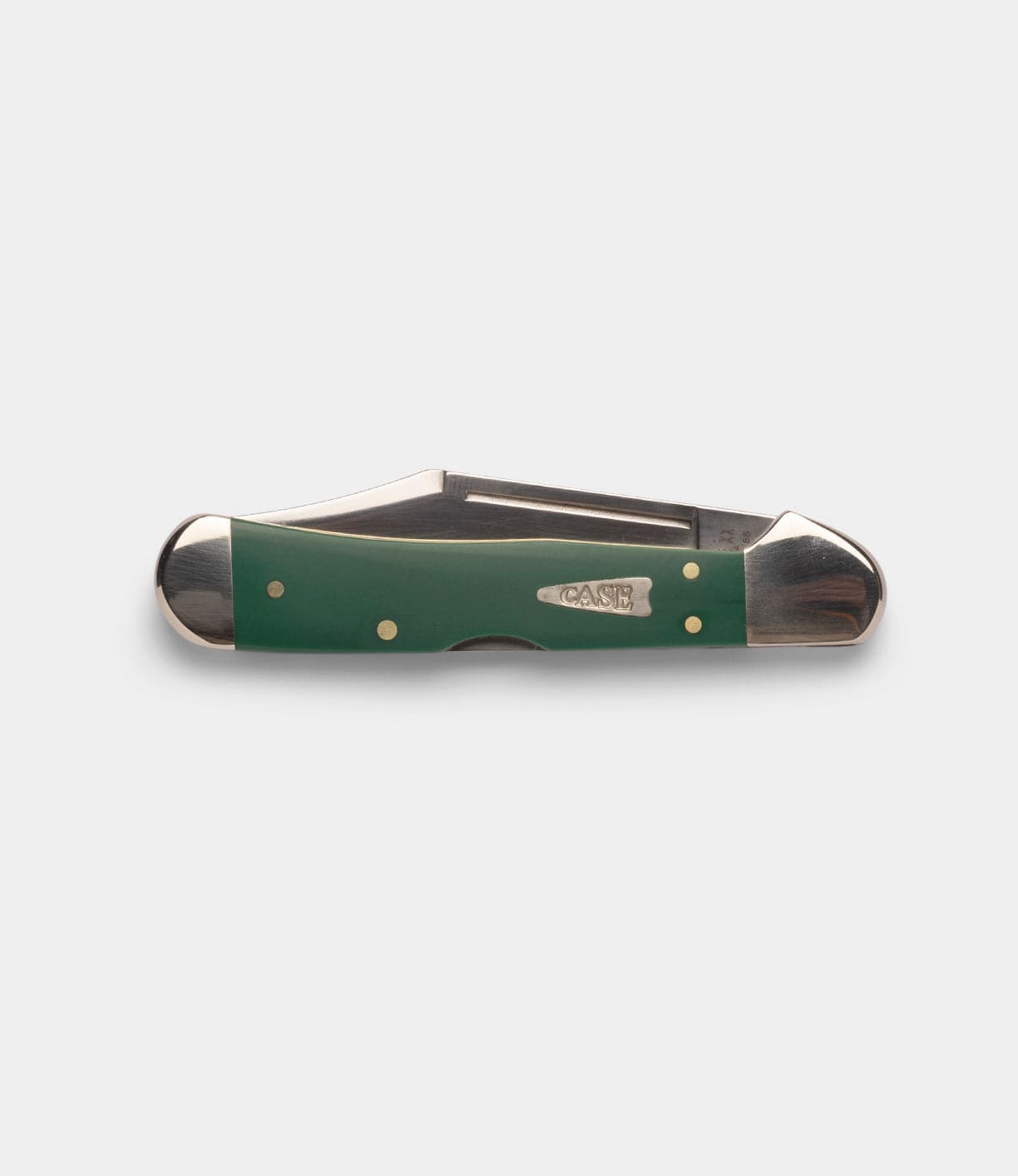 A closed Best Made Co Mini Copperlock pocket knife with a green handle, silver bolsters, and brass pins—featuring "BEST MADE CO" engraved on the side—is shown against a plain white background.