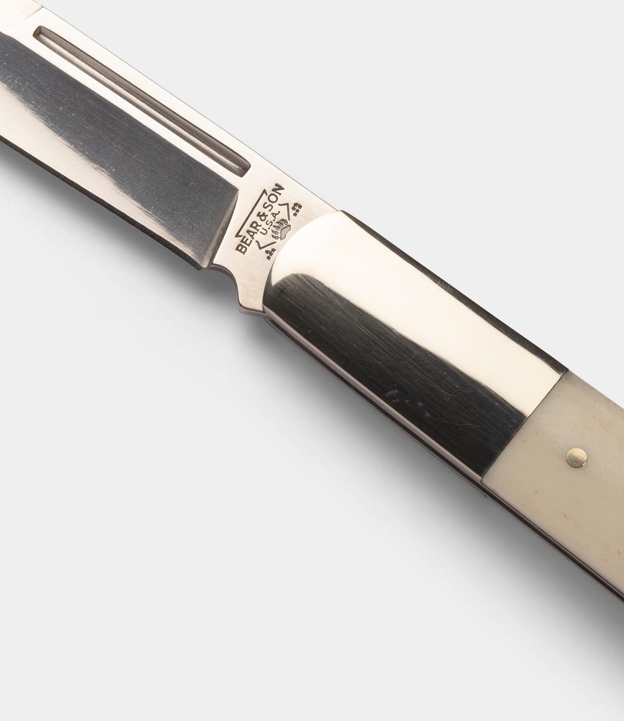 Close-up of a Best Made Co Barlow Knife featuring a polished stainless steel blade and a cream-colored bone handle. The blade is stamped with the BELGSON name, 2564, and a small logo.