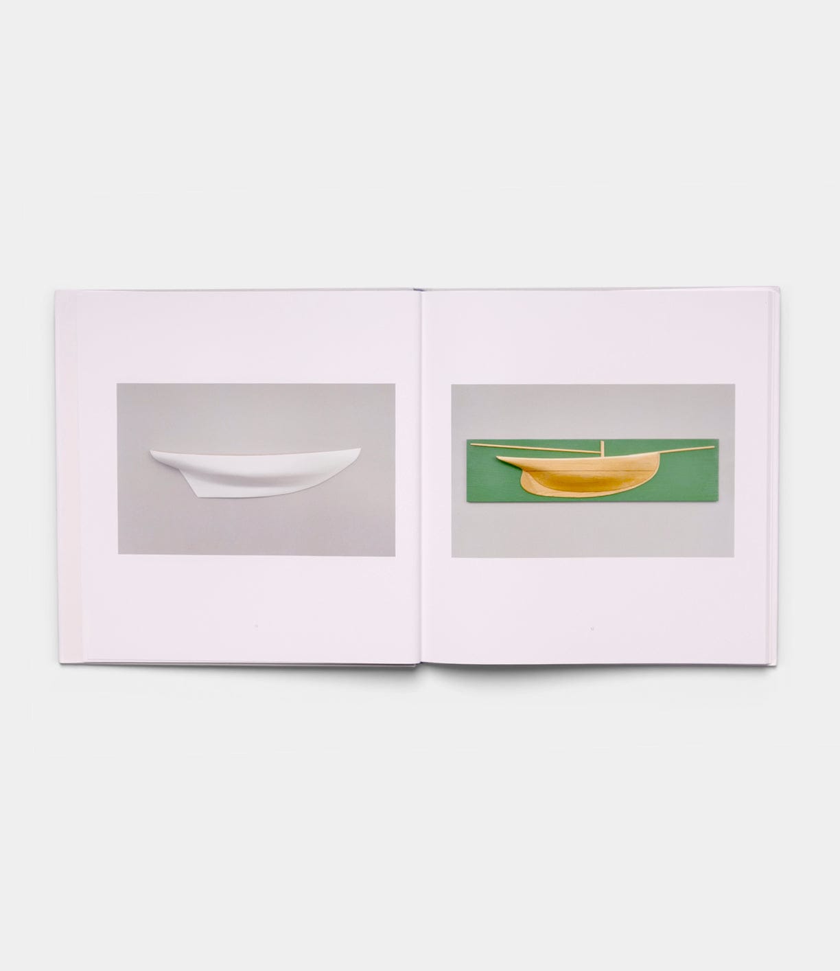 The "Boats, Books, Birds" book by Best Made Co. is open to two minimalist pages: the left shows a white boat model on gray, while the right features a yellow boat model on green.