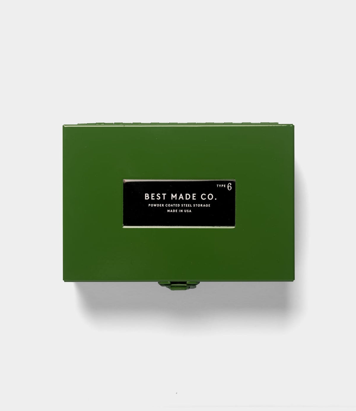 The Best Made Co. Type 6 Strongbox Green is a durable powder-coated steel storage box, featuring a black and white label that reads “Best Made Co. Type 6 Powder Coated Steel Storage Made in USA.” Placed on a plain light gray background, this strongbox from the Best Made collection offers secure storage for your valuables.