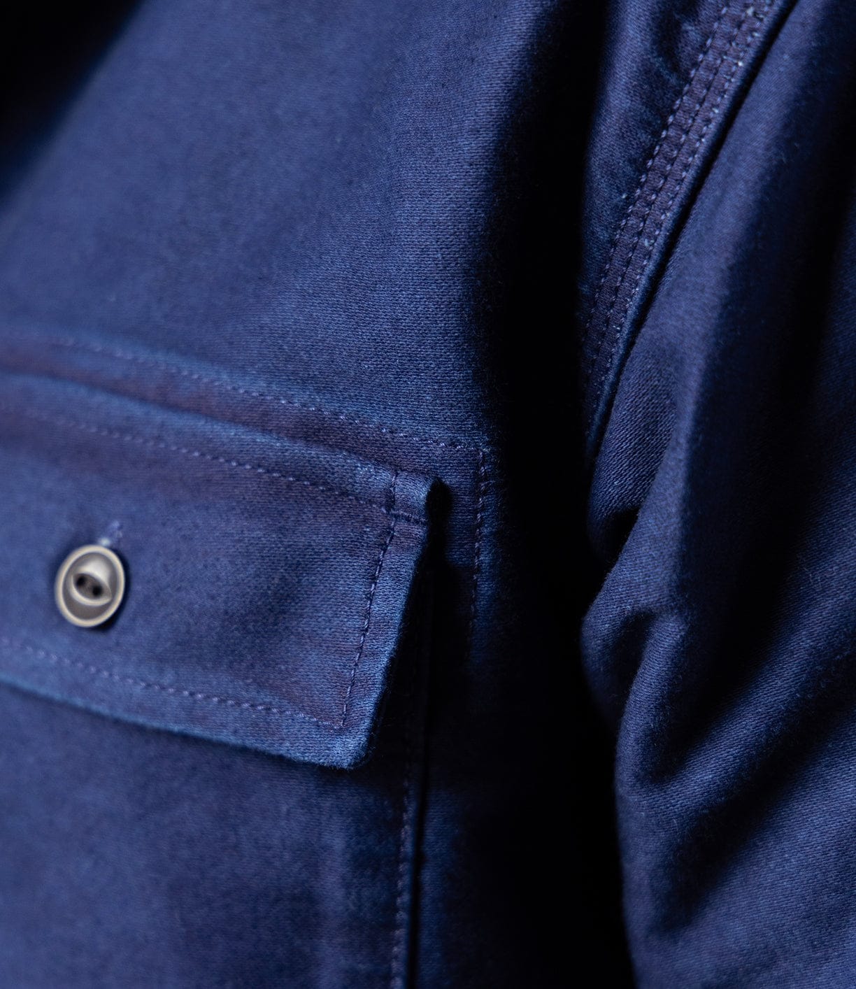 Close-up of the Best Made Co Indigo Moleskin Work Shirt in navy, featuring a soft, slightly textured fabric, a buttoned chest pocket, and visible stitching details.