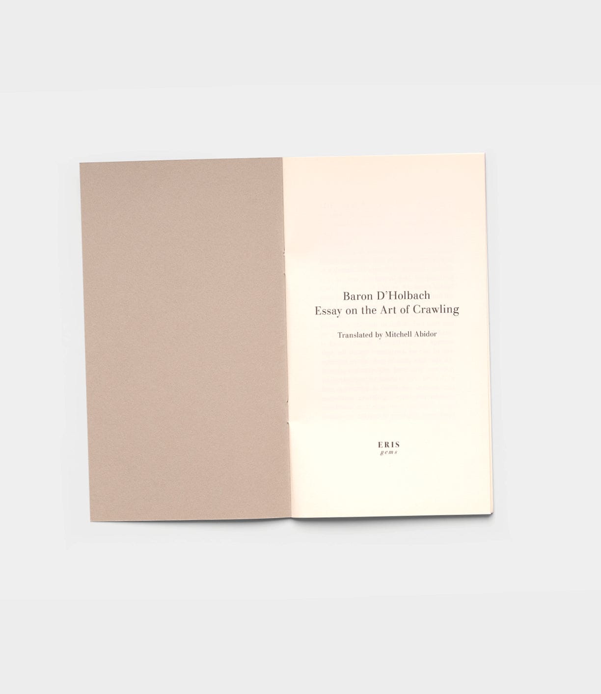 An open book shows its title page: Essay on the Art of Crawling by Best Made Co., with a plain inside cover on the left.