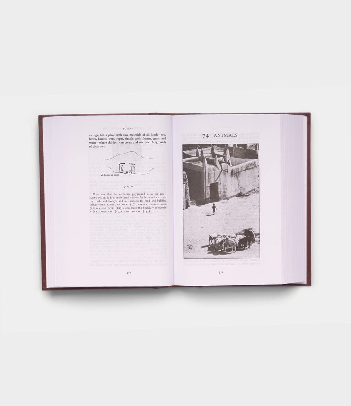 An open copy of "A Pattern Language" by Best Made Co. shows text and a diagram on the left page, while the right page, titled "74. ANIMALS," features a black-and-white photo of animals and people outdoors.