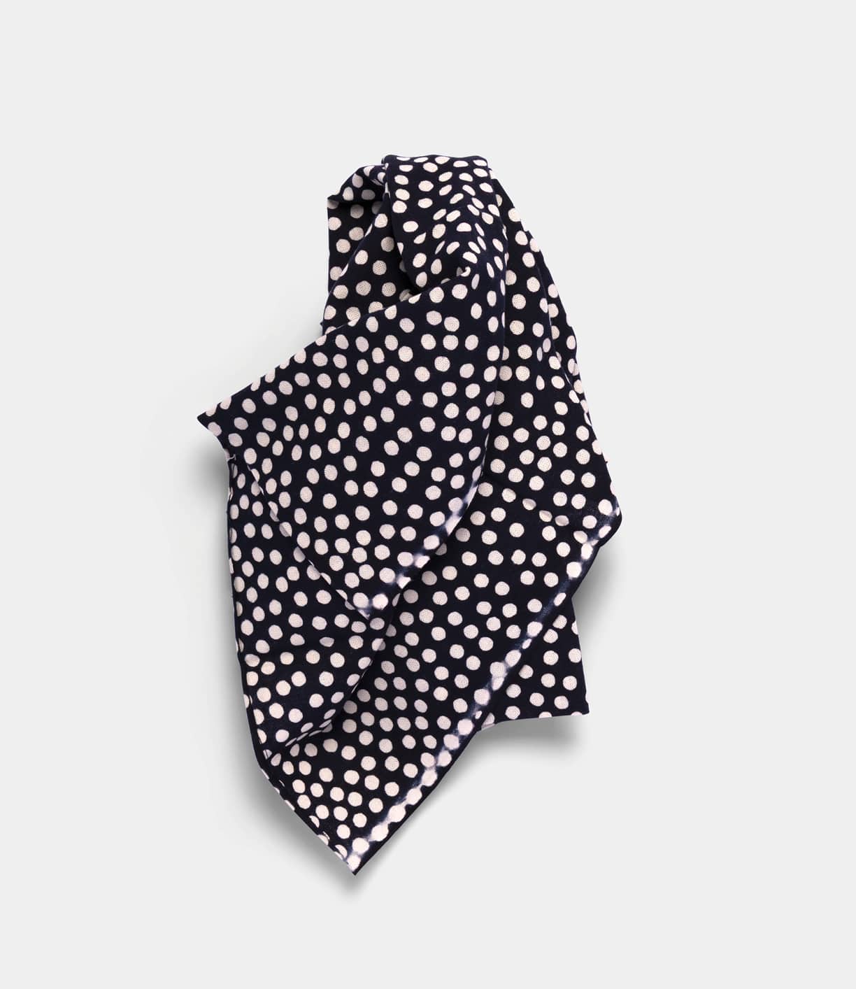 The Arare Tenugui by Best Made Co. is a navy blue, hand-dyed Japanese cloth featuring white polka dots, made using the chusen technique and shown loosely folded on a light gray background.