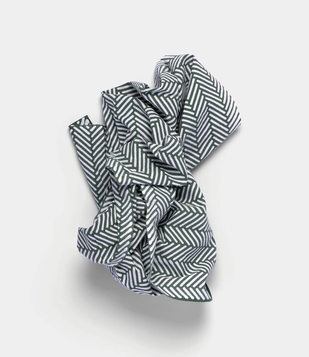 The Sugi-Aya Tenugui by Best Made Co., featuring a hand-dyed black and white herringbone pattern, is crumpled on a plain light background.