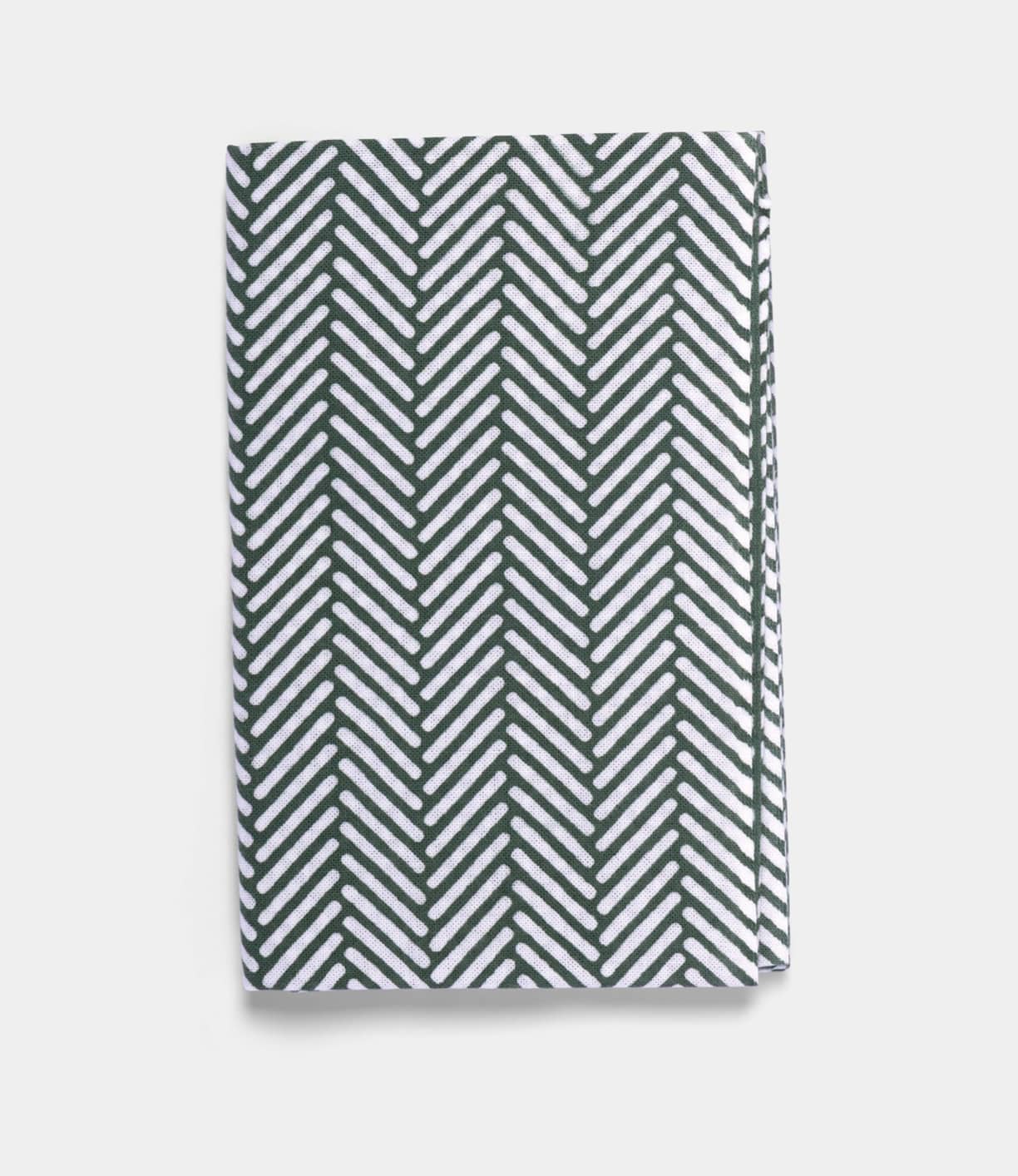 The Sugi-Aya Tenugui by Best Made Co. is a folded, hand-dyed Japanese cloth with a white background and dark green herringbone pattern, crafted using the traditional chusen technique.