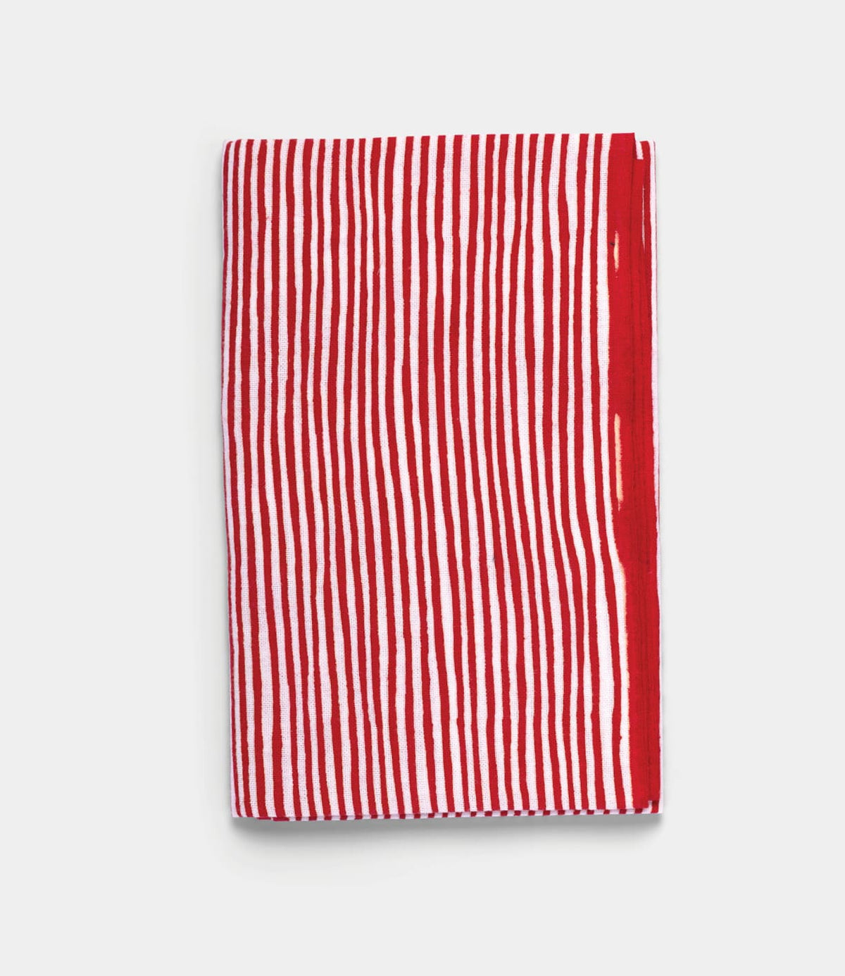 The Yoroke-Jima Tenugui by Best Made Co. features vertical red and white stripes on a plain white background, hand-dyed using the traditional Japanese chusen technique.