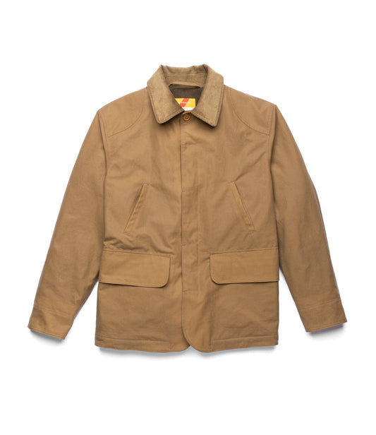 The Best Made Co. Wool-Lined Waxed Field Jacket in tan is weather-resistant, featuring a corduroy collar, button front, large front pocket, dark brown fleece lining, and an inner green pocket with a purple label.