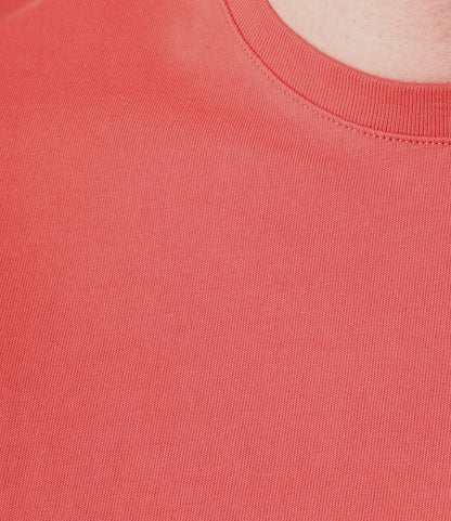 Close-up of a person wearing the Best Made Co. Standard T-Shirt Faded Red, crafted from soft Peruvian tangüis cotton, highlighting the textured fabric and collar with a glimpse of skin near the neckline.
