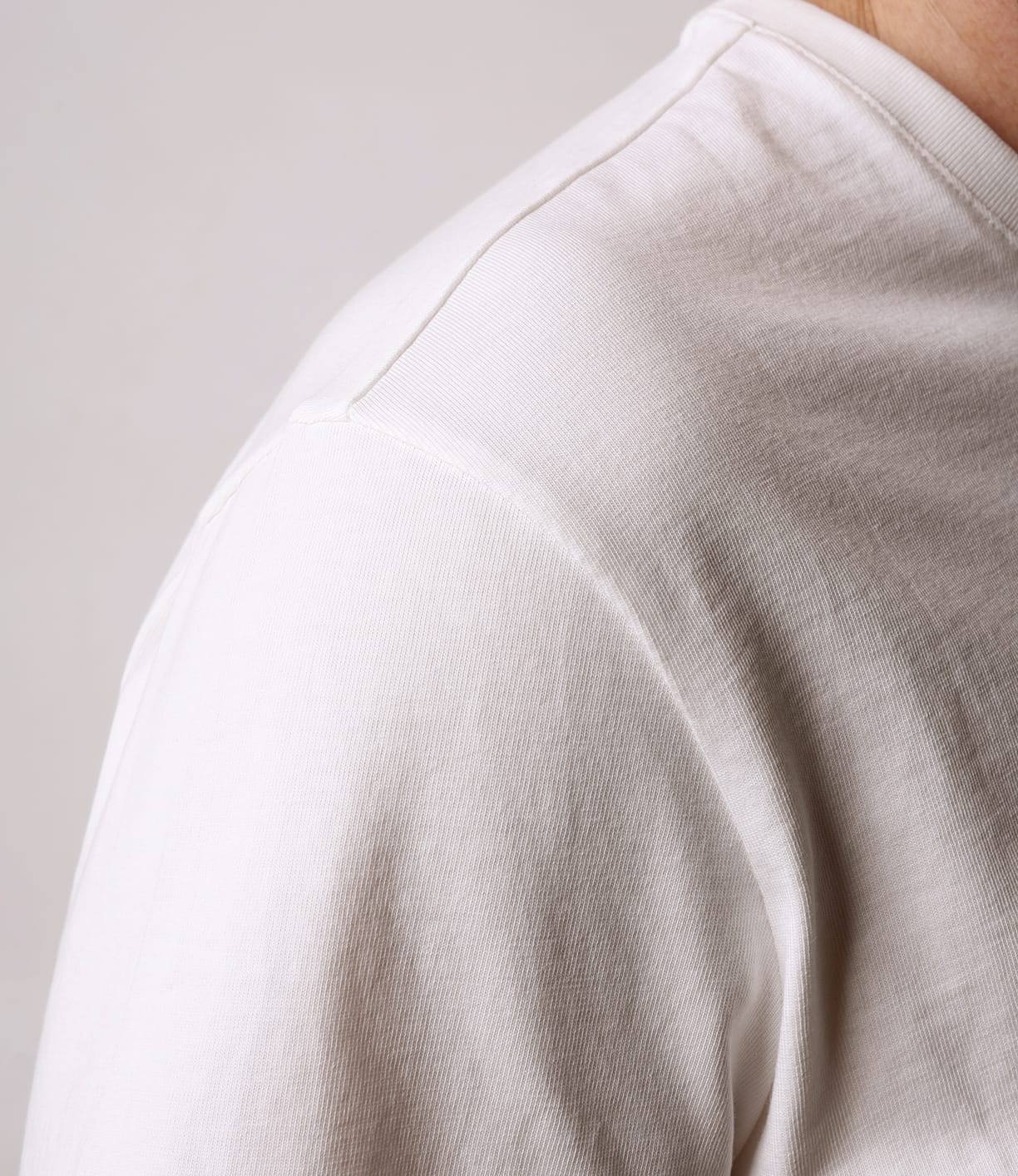 Close-up of a person in the Best Made Co. Standard T-Shirt Undyed, highlighting the upper shoulder and neckline against a light background—an essential everyday piece for any wardrobe.