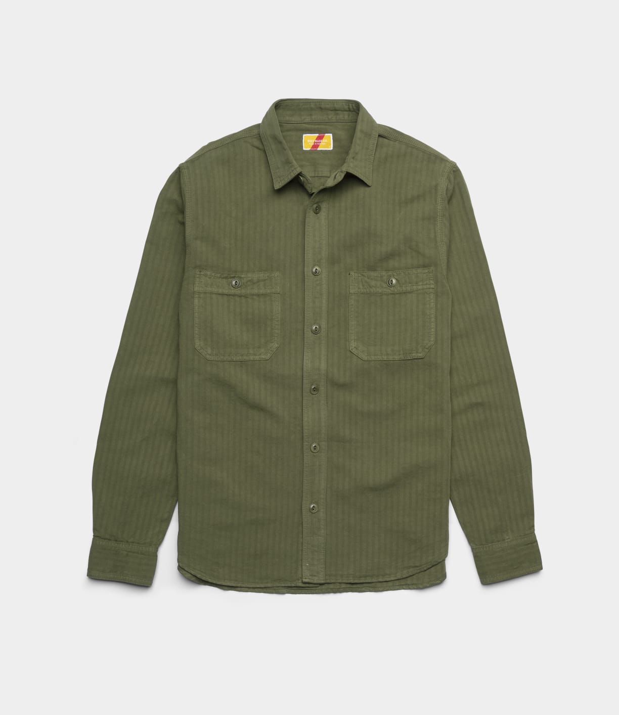 The Best Made Co. Cotton-Linen Workshirt in Olive Drab, featuring long sleeves, a button-up front, collar, and two button-flap chest pockets, made from Japanese workwear fabric, laid flat on a white background.