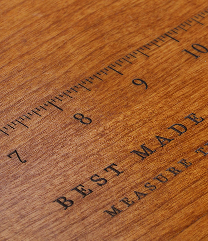 A close-up of a wooden ruler with black markings, showing numbers 7 to 10, rests on a Best Made Co. 41D Gerstner Chest 2026. "BEST MADE" is partially visible below the ruler's marks.