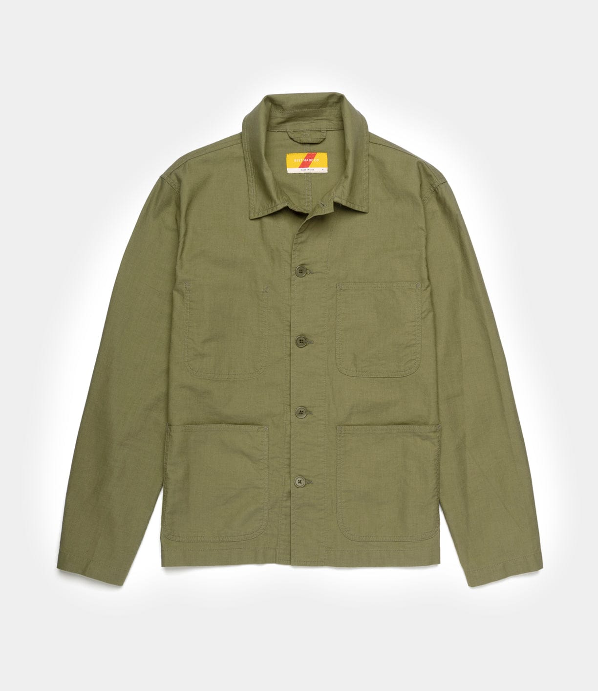 The Best Made Co. Panama Cloth Service Jacket is an olive green, button-up chore jacket with a collar and three front patch pockets, inspired by the classic P-41 Marine Corps jacket, crafted from Japanese cotton Panama cloth and shown flat on a white background.