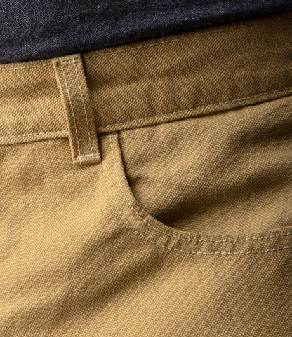 Close-up of the Best Made Co. Standard 5-Pocket Pant M2 Khaki, highlighting the waistband, belt loop, and front pocket with visible stitching. The heavyweight cotton pants are shown in khaki and paired with a dark shirt above.