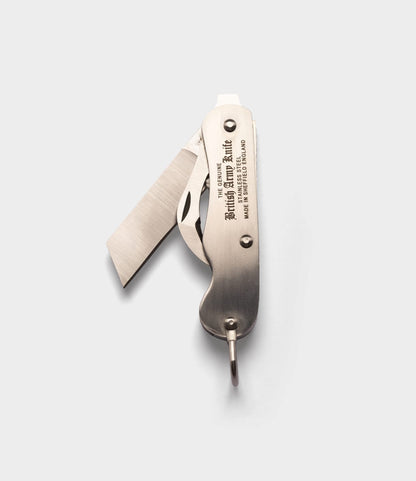 The Best Made Co. British Army Knife, a stainless steel folding pocket knife with two extended blades and engraved handle, is displayed against a plain light gray background.