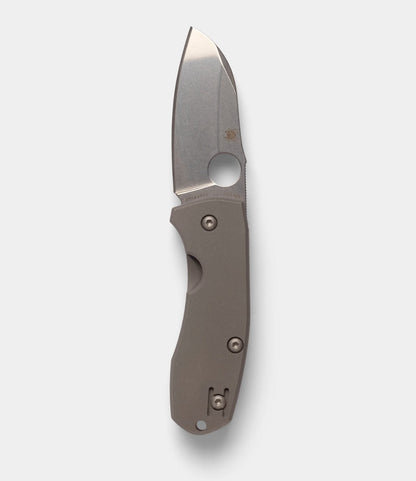 The Best Made Co. Spyderco Techno 2 is a folding pocket knife with a wide, short CTS-XHP steel blade, matte metallic handle, thumb hole for easy opening, and tough titanium framelock—all shown against a plain light gray background.
