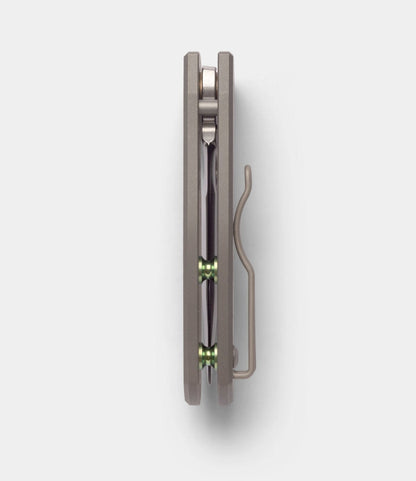 Spyderco Techno 2 by Best Made Co. shown closed from above, featuring a titanium framelock handle, metal pocket clip, and two green pivot rings on a plain light background.