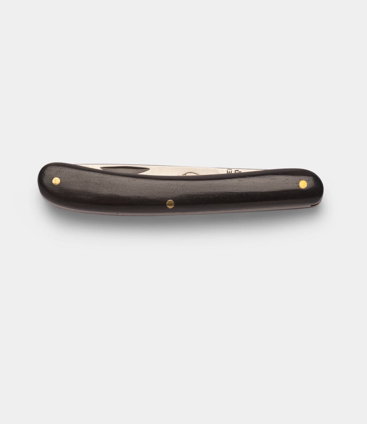 A closed Best Made Co Little Doctor Knife with a dark wooden handle and brass rivets, photographed on a white background.