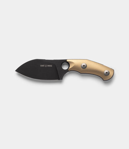 The Best Made Co. GiantMouse GMF1-P (BMC Edition) is a fixed-blade knife with a matte black blade, finger hole, and textured tan handle with two metal rivets. Shown on a light gray background with its handmade leather sheath included.