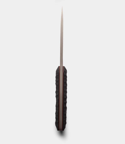 A straight-on view of a closed Best Made Co. NWBW Field Knife (BMC Edition), featuring a textured black handle and slim, pointed D2 tool steel blade displayed vertically against a light background.