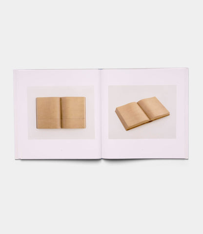 An open book, "Boats, Books, Birds" by Best Made Co., shows two photos of a wooden sculpture shaped like an open book from different angles on plain white pages.