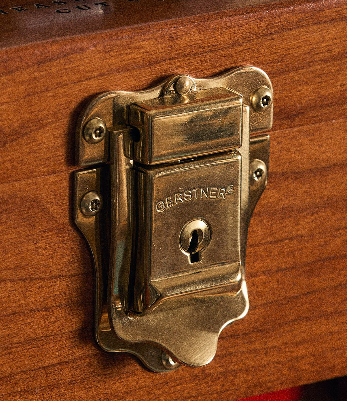A close-up of a shiny brass lock engraved with “Best Made Co.” and mounted on the rich American cherry wood of the Gerstner 41D Founder’s Edition tool chest highlights the exceptional craftsmanship characteristic of this classic piece.