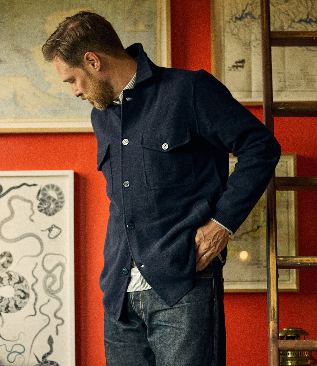 A man wearing a navy blue Knit Lambswool CPO with two chest pockets.
