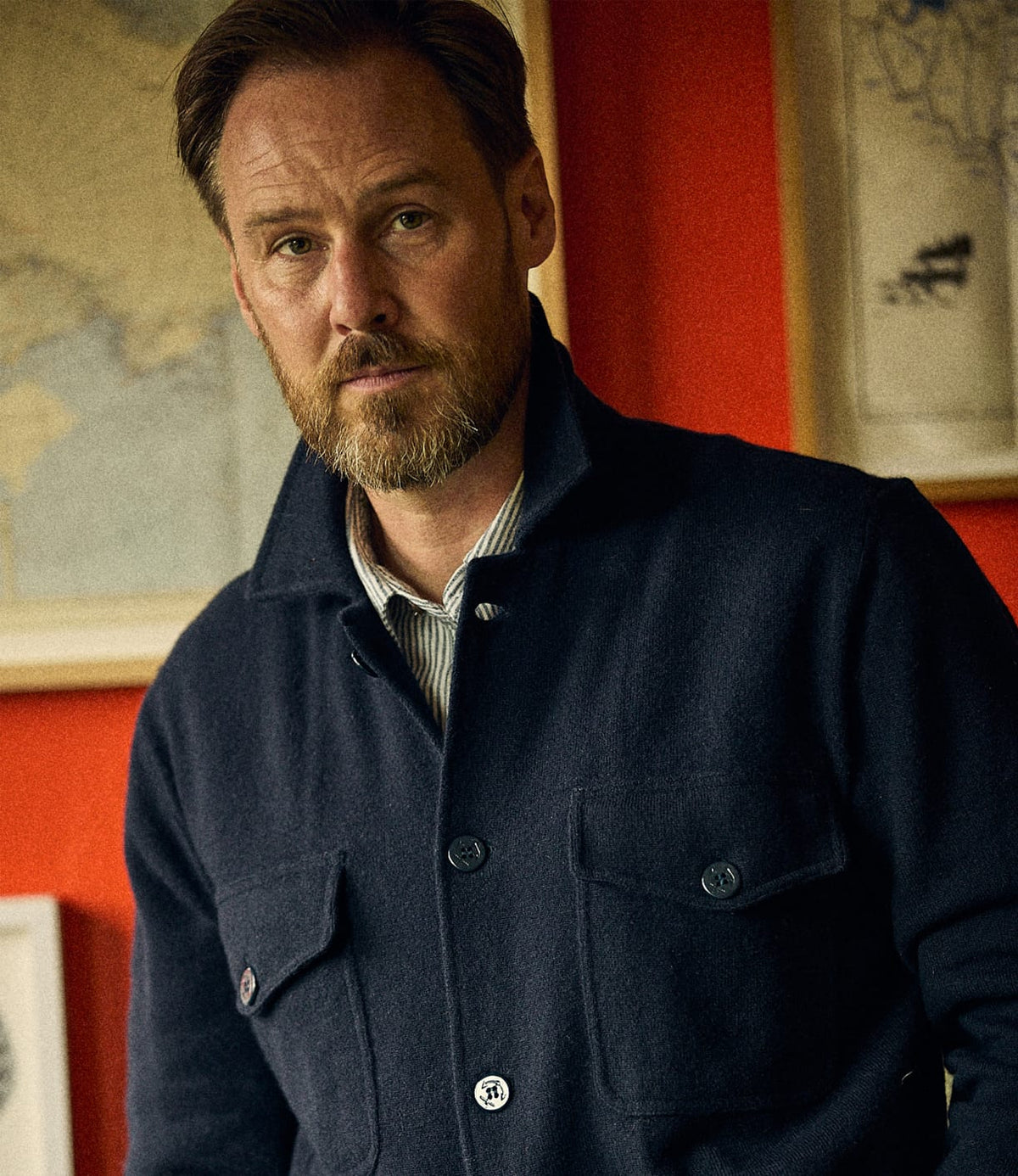 A man wearing a dark blue Best Made Co. Knit Lambswool CPO shirt with two chest pockets.