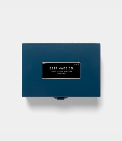 A rectangular blue Type 6 Strongbox by Best Made Co., crafted from durable steel and featuring a distinctive black and white “Best Made Co.” label on the lid, is photographed against a plain white background. Proudly made in the USA, this strongbox exemplifies reliable construction and quality craftsmanship.