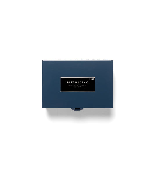 A rectangular blue Type 6 Strongbox by Best Made Co., crafted from durable steel and featuring a distinctive black and white “Best Made Co.” label on the lid, is photographed against a plain white background. Proudly made in the USA, this strongbox exemplifies reliable construction and quality craftsmanship.