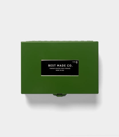 The Best Made Co. Type 6 Strongbox Green is a durable powder-coated steel storage box, featuring a black and white label that reads “Best Made Co. Type 6 Powder Coated Steel Storage Made in USA.” Placed on a plain light gray background, this strongbox from the Best Made collection offers secure storage for your valuables.