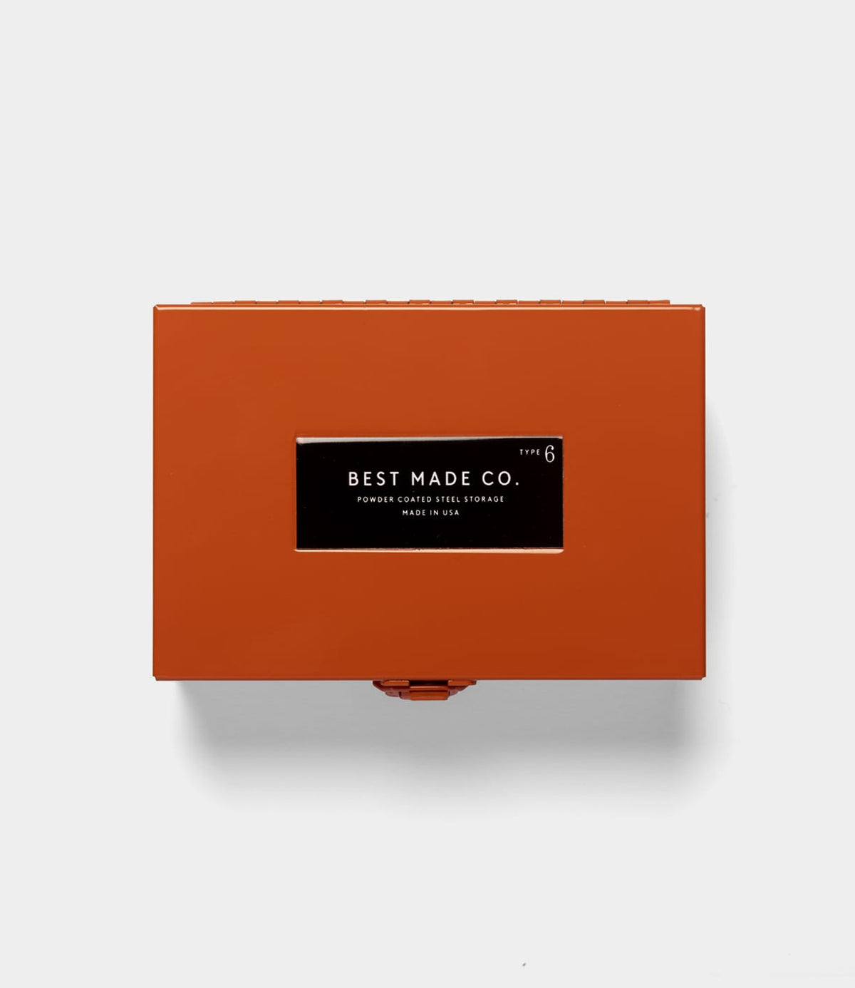 A rectangular, orange Type 6 Strongbox by Best Made Co. sits centered on a plain, light gray background, exemplifying secure storage and the reliability of a durable steel box.
