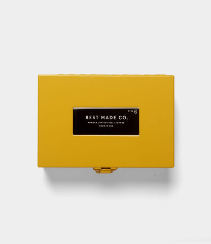 A Best Made Co. Type 6 Strongbox Yellow, a durable rectangular steel storage box with a yellow powder-coated finish and a black label reading “Best Made Co. Type 6, Powder Coated Steel Storage, Made in USA,” is displayed against a plain white background.