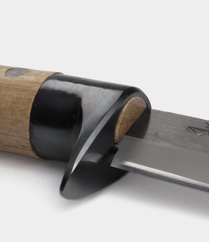 Close-up of the Best Made Co. Hotta San Hunting Knife, highlighting its wooden handle, black guard, and Yasuki blue steel blade against a plain white background.