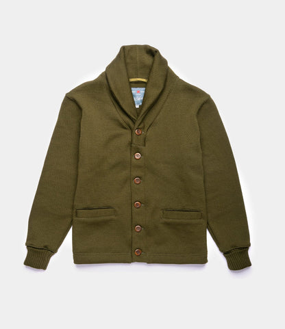 The Dehen Shawl Neck Sweater in Moss Green by Best Made Co. features a classic shawl collar, long sleeves, ribbed cuffs, brown buttons, and two front pockets—a timeless worsted wool cardigan shown laid flat on a white background.