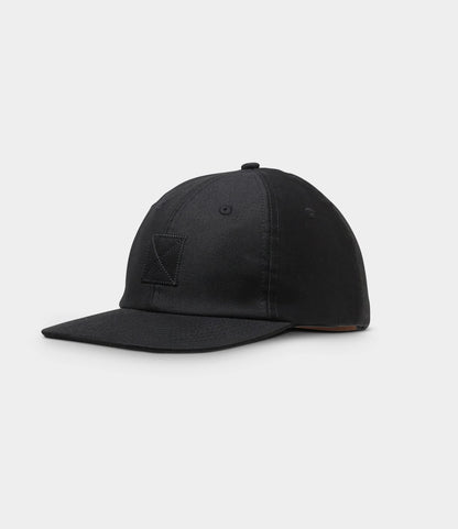 The Military Cord Ball Cap Black by Best Made Co. is a plain black corduroy cap with a curved brim, small stitched square on the front, and leather adjustment strap, displayed against a light gray background.