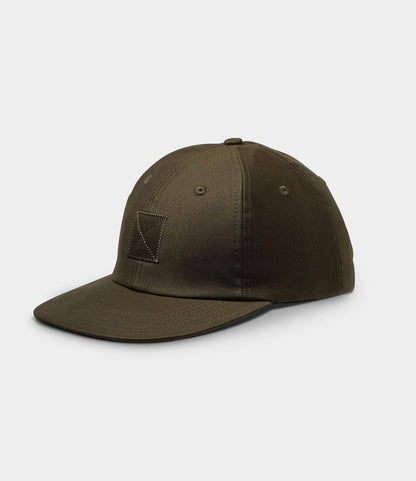 The Best Made Co. Military Cord Ball Cap Olive Drab is a dark olive corduroy cap with a flat brim, small stitched square front patch, and a leather adjustment strap, shown against a light grey background.