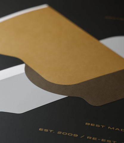 Close-up of the “Good as Gold” silk-screened poster by Best Made Co., a minimalist work with overlapping tan, brown, and gray shapes on dark background and subtle gold text—ideal as a limited edition wall art piece.