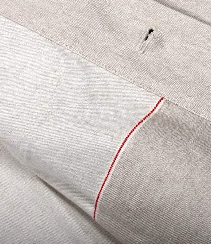 Close-up of the Selvedge Natural Studio Jacket by Best Made Co., crafted from premium denim with a visible red selvedge line and buttonhole, highlighting fine texture, stitching, and superior American craftsmanship.
