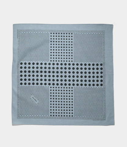 The Trademark Bandana Blue by Best Made Co. is a light blue square scarf with large and small dark blue dots in geometric rows, hand-printed and finished with a selvedge edge and a small rectangular tag in one corner.