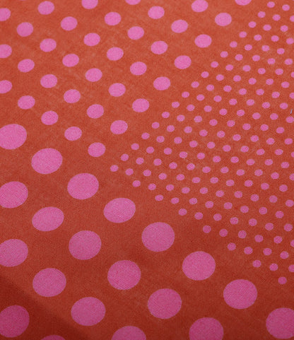 The Best Made Co. Trademark Bandana Red features hand-printed pink polka dots of various sizes, forming a gradient across an orange background, with denser dots on one side that become sparser and smaller toward the selvedge.