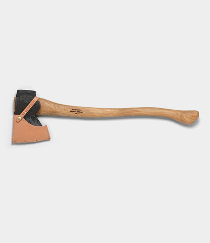 The Phantom by Best Made Co. is a Rockaway pattern axe with a wooden handle, black metal head, and tan leather sheath, shown on a plain light gray background.
