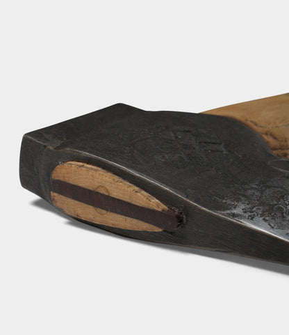Close-up of the base of The Phantom by Best Made Co., revealing a worn, flat bottom with a lighter wood oval inset and dark stripe—details reminiscent of fine craftsmanship found in premium axe handles.