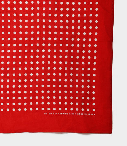 A red fabric with a grid of evenly spaced white dots. Near the edge, white text reads BEST MADE CO. / MADE IN JAPAN. This Semaphore Bandana is hand-printed in Japan, shown partially against a plain background.