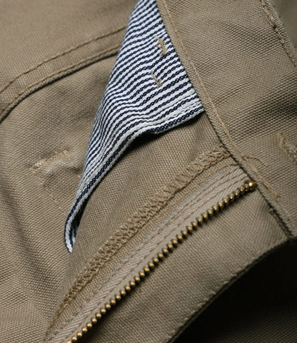 Close-up of the Best Made Co. Standard 5-Pocket Pant in tan, featuring an open zipper, blue and white striped pocket lining, visible stitching details, and straight leg design that highlights its texture and craftsmanship.