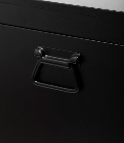 Close-up of a black metal handle on the Best Made Co. Rolling Footlocker, crafted from dark 22-gauge steel with a smooth matte finish—a sturdy storage solution.