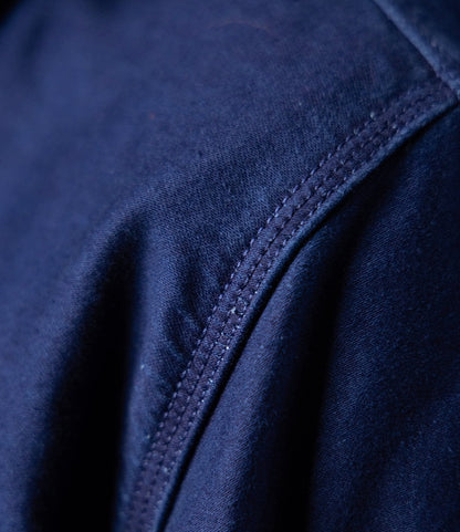 Close-up of the Indigo Moleskin Work Shirt by Best Made Co., showing navy blue fabric with visible seam stitching and a soft, textured surface.