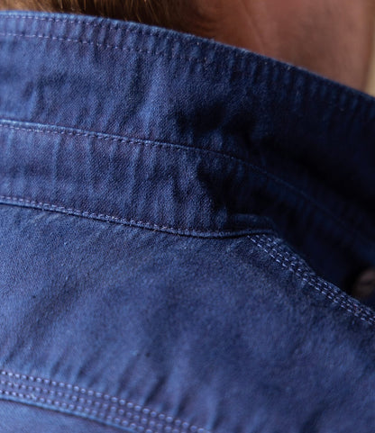 Close-up of the back neckline and shoulder of a Best Made Co Indigo Moleskin Work Shirt, showing detailed stitching and high-density fabric. Light brown hair is slightly visible at the top.