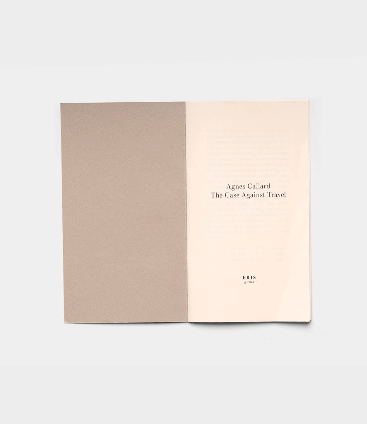 An open book displays the title page reading "The Case Against Travel" by Best Made Co., with ERIS and 2023 below. The left page shows a blank brownish cover, against a plain light gray background.
