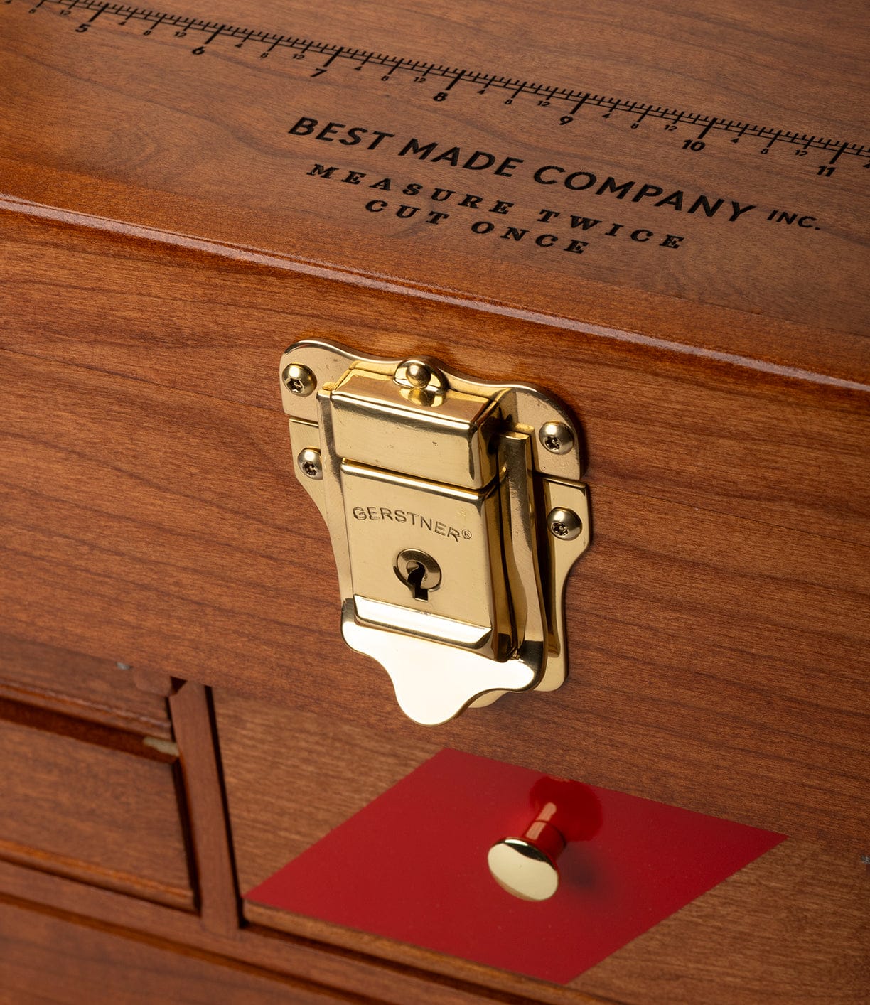Close-up of the Gerstner 41D Founder's Edition by Best Made Co., featuring a brass GERSTNER® latch, small drawers, and a lid inscribed with MEASURE TWICE CUT ONCE and BEST MADE COMPANY INC., evoking a classic machinist chest.